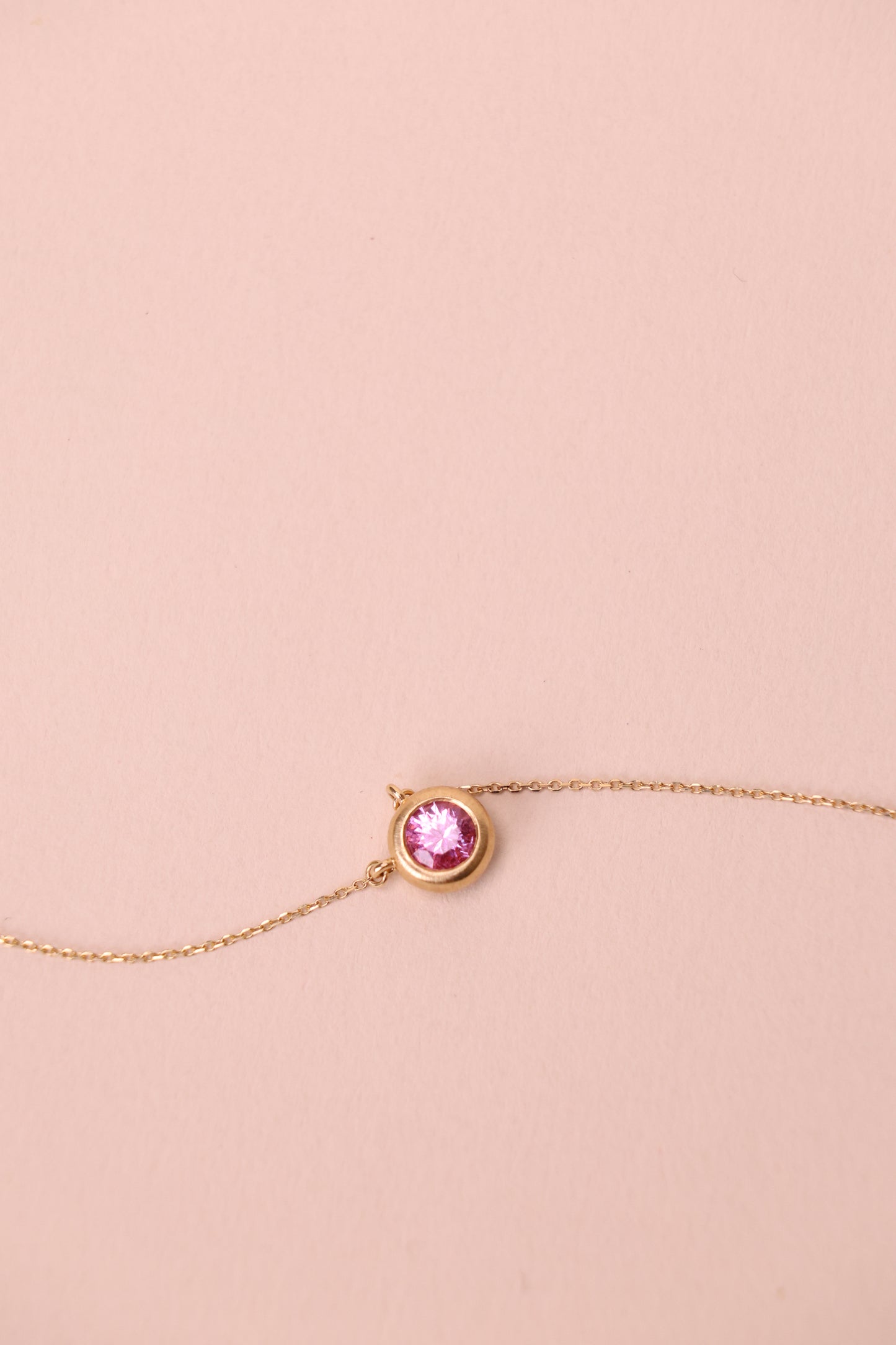 Bezel-set padparadscha necklace in 18k yellow gold