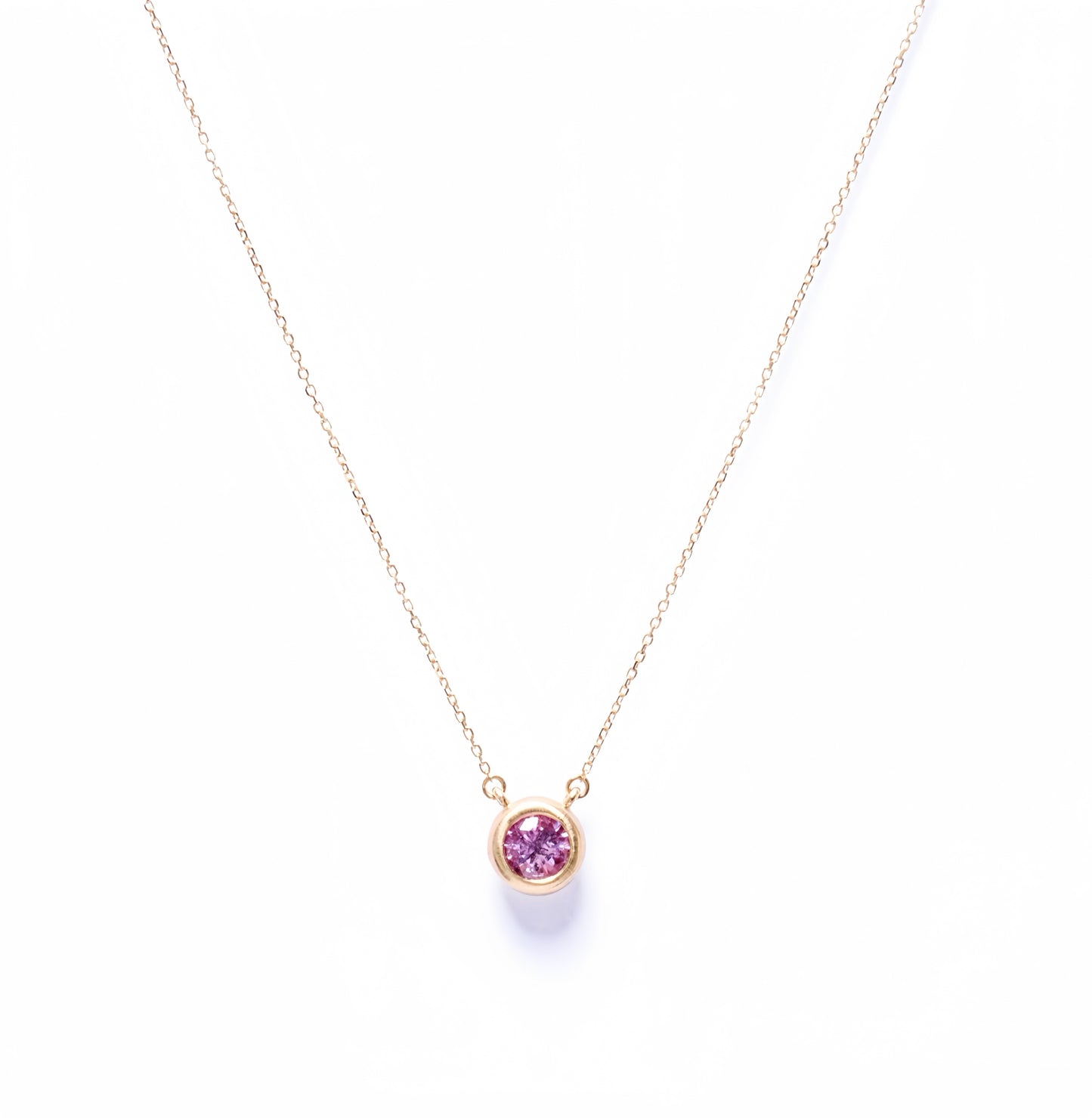 Bezel-set padparadscha necklace in 18k yellow gold